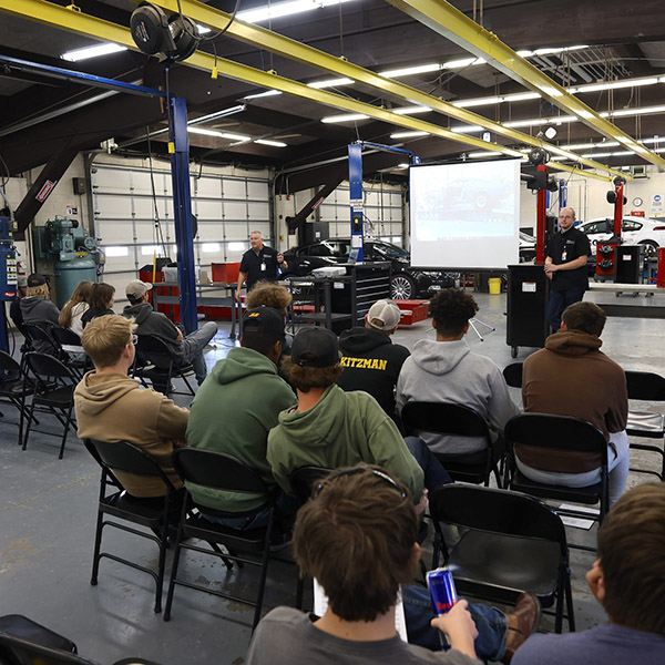 Students watching a presentation in an auto class
