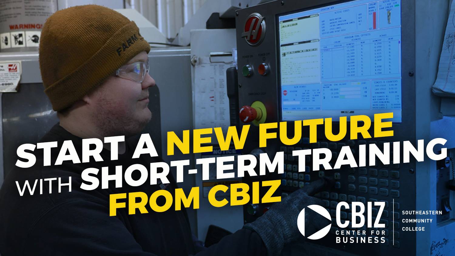 Man in hat and glasses using computer