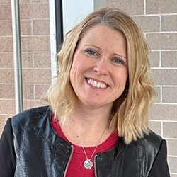 Smiling female in red shirt and black jacket