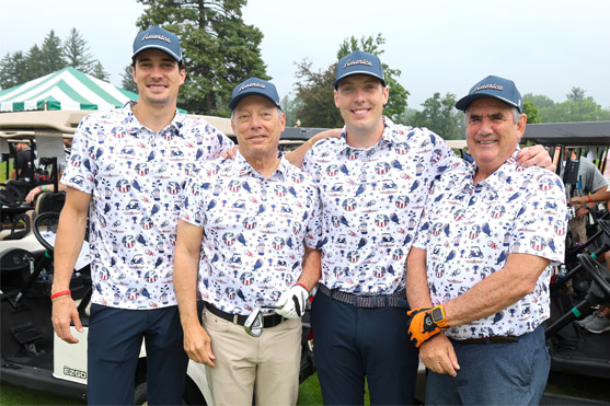 Four male golfers smiling