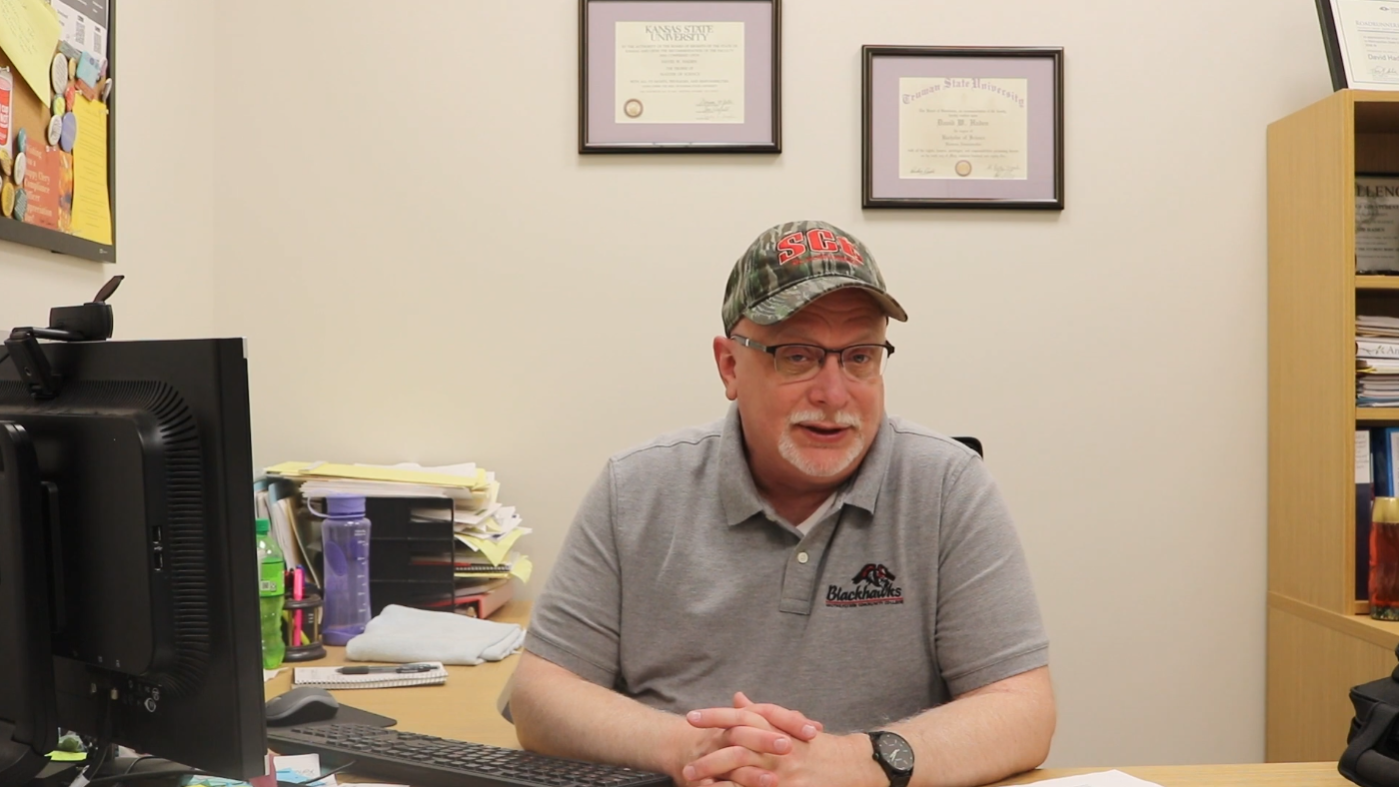 Dean of Students Dave Haden sitting at his desk